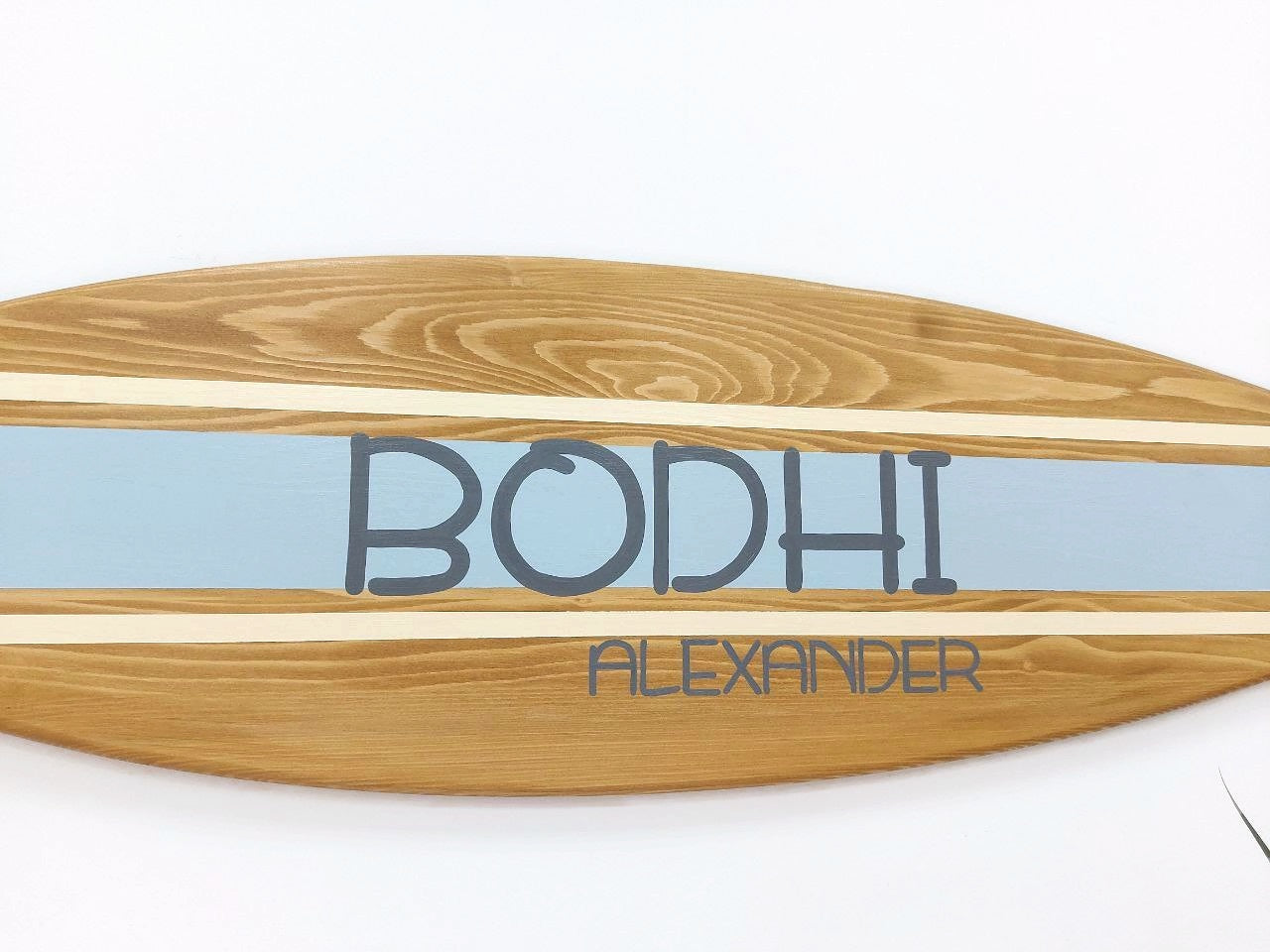 Close-up of engraved name on custom surfboard wall art