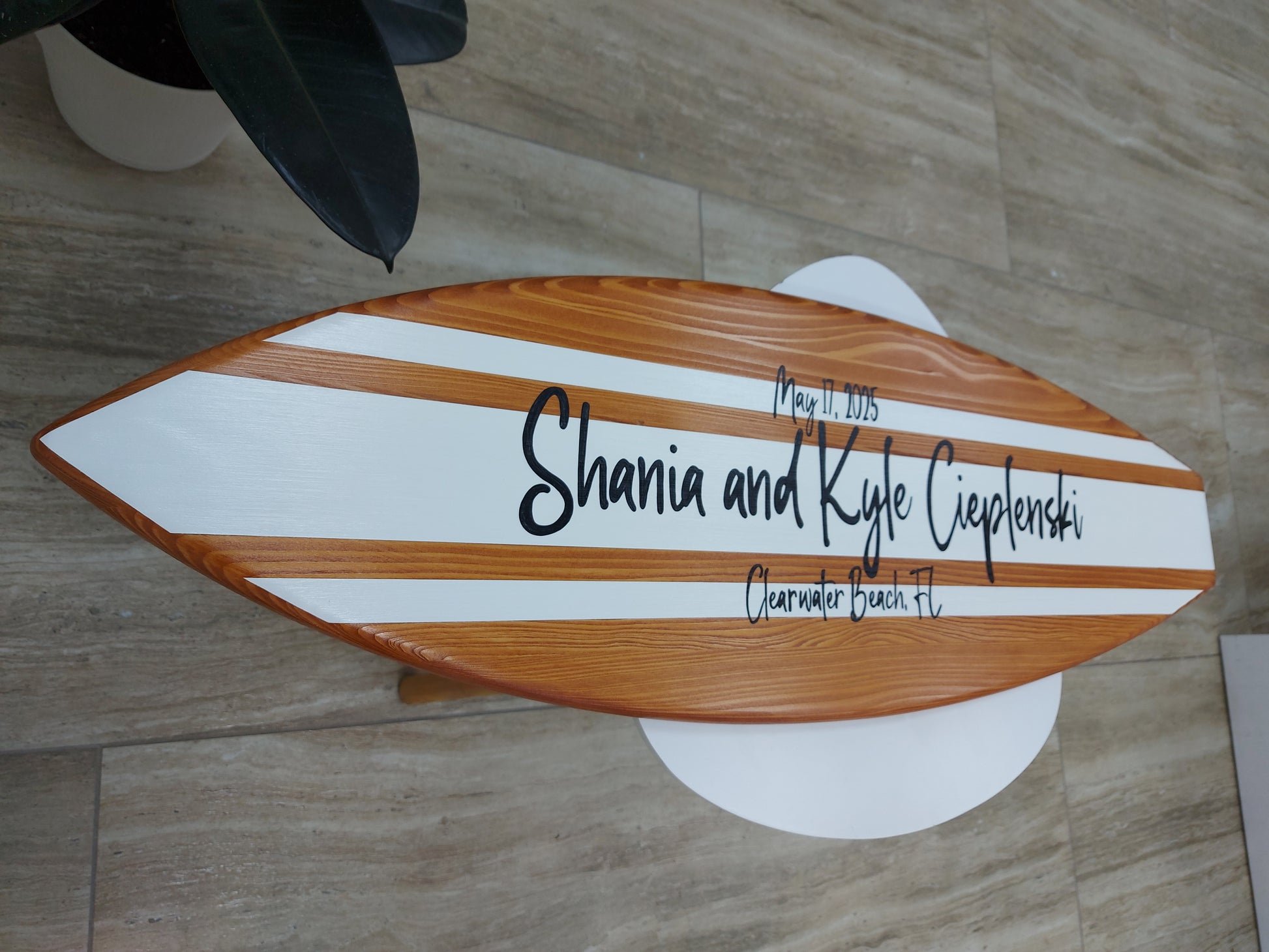 Close up of wood grain and painted details on surfboard wedding guest book sign