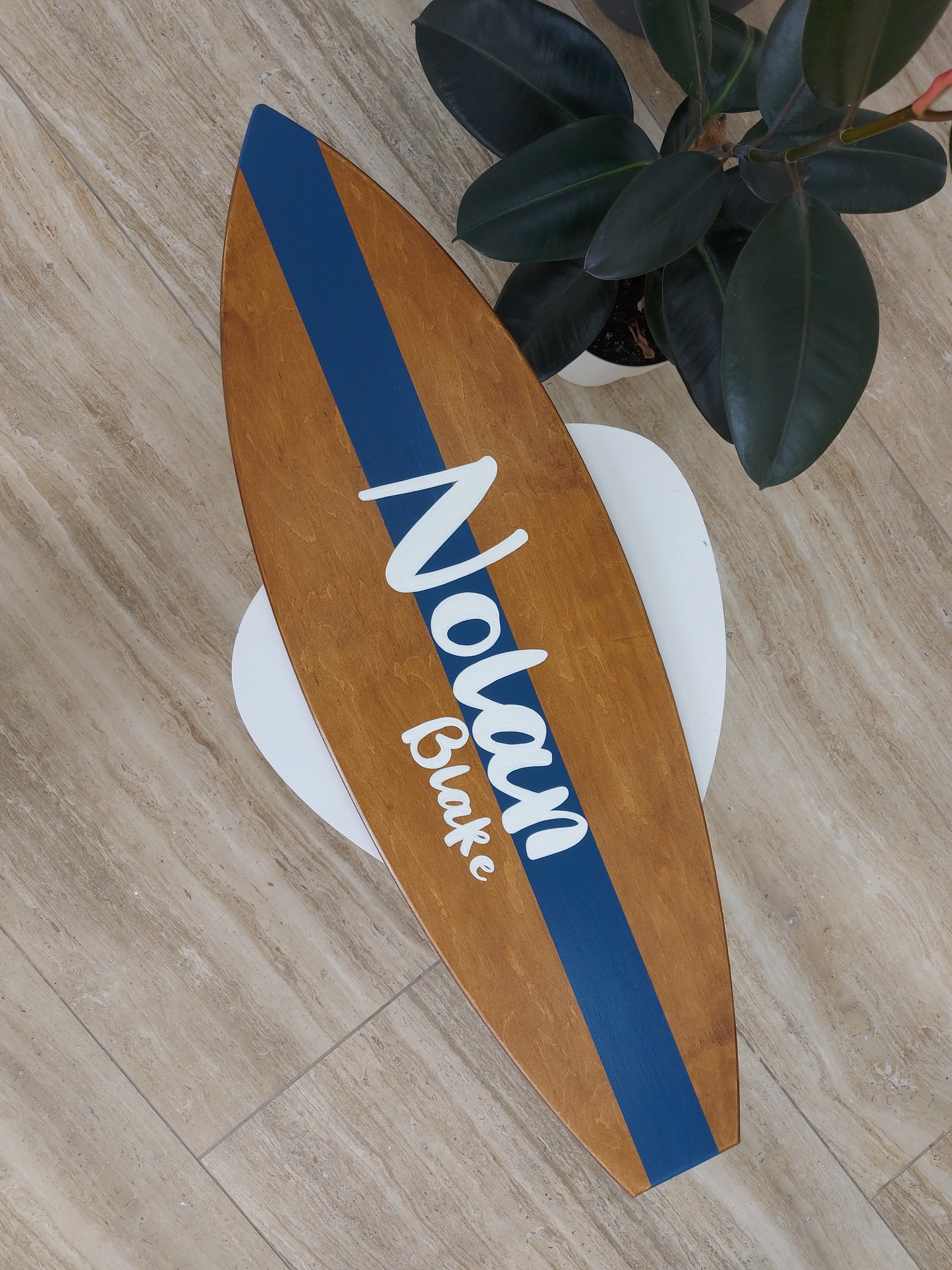 Close-up of custom name engraving on wooden surfboard wall art, perfect gift idea