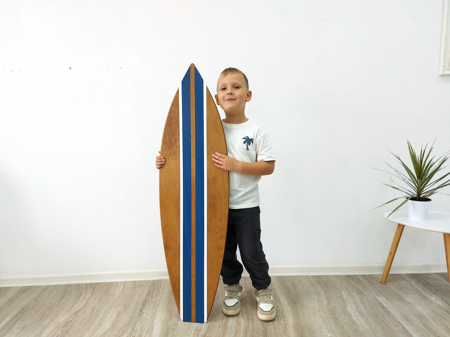 Wooden surfboard with blue stripes 