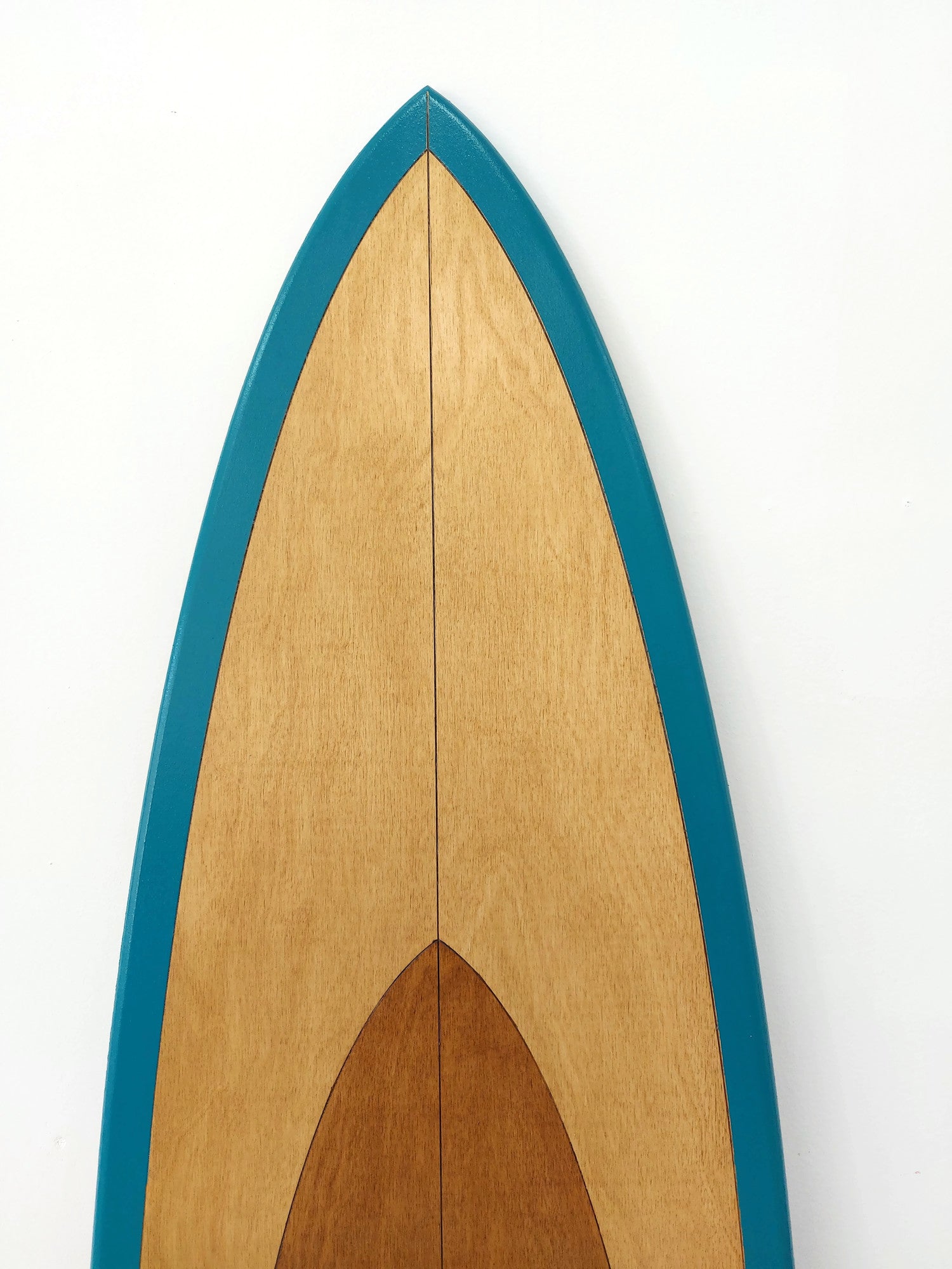 Wooden surfboard with blue rim on a white background