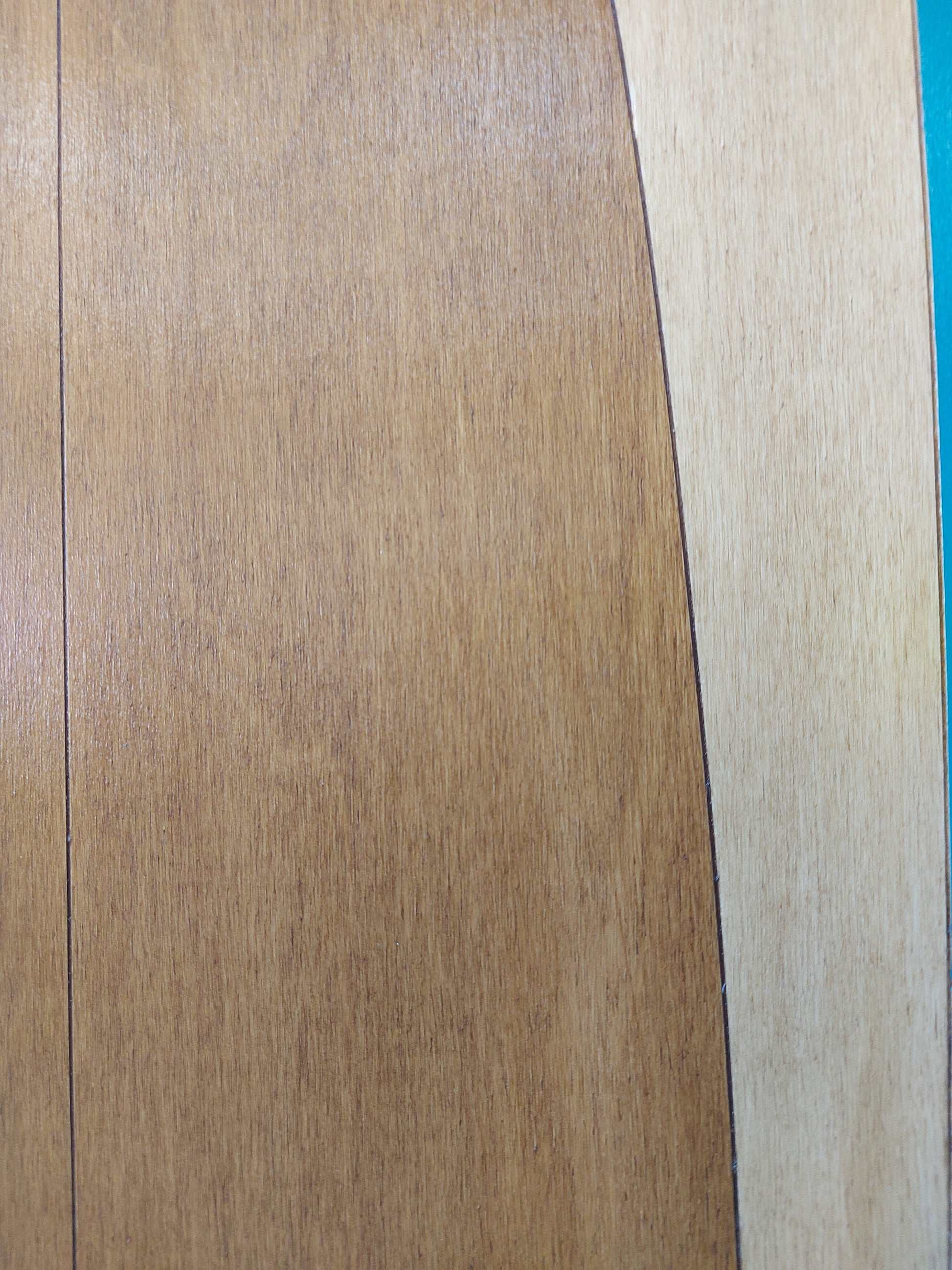 Close-up of decorative surfboard with a visible grain pattern.