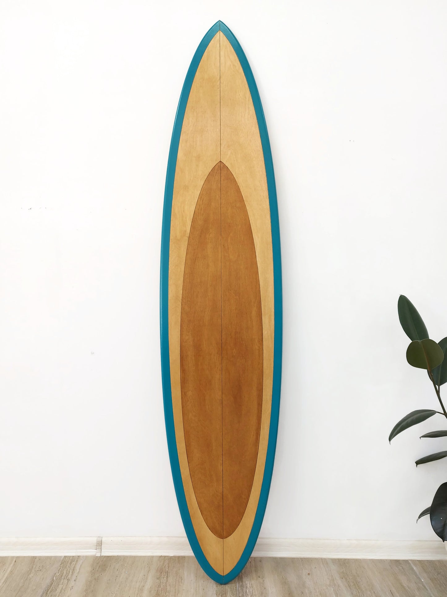 Wooden surfboard wall art with teal trim, front view showing natural wood grain